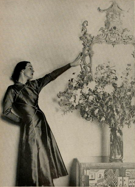 "Don Loper's version of the the increasingly important costume dress... a Regency breakaway coat with separate skirt, in pure silk serge; iridescent black rose or black pearl." The Californian, August 1948